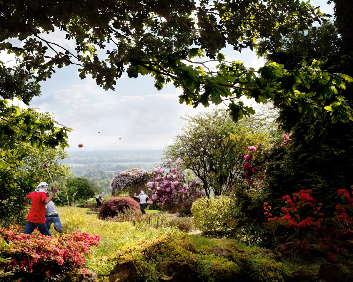 English country landscape in the summer with young men fighting