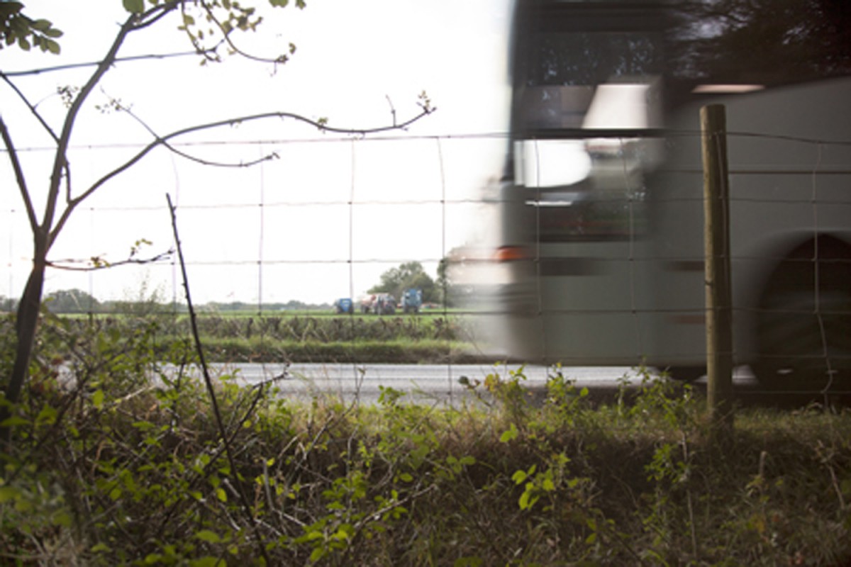 blurred, bus, fence, road, bushes